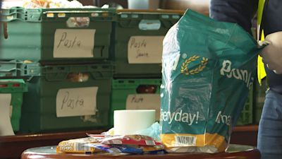 A carrier bag being filled at a food bank