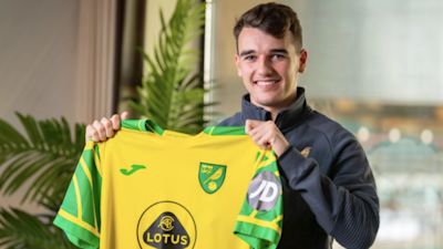 Liam Gibbs poses with his new Norwich City shirt.