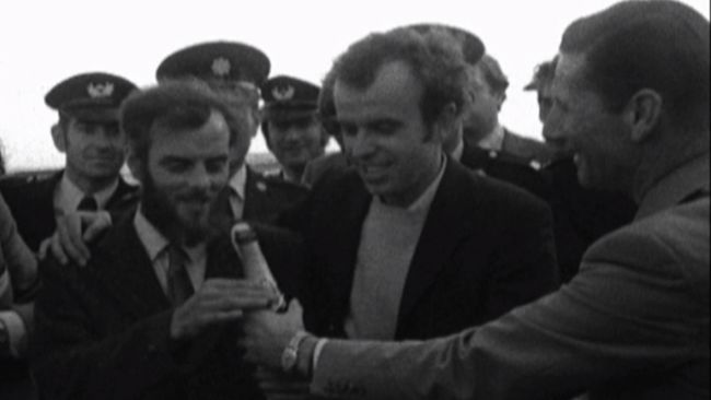 The two Cumbrian survivors rescued from the stricken submarine celebrating with a bottle of champagne