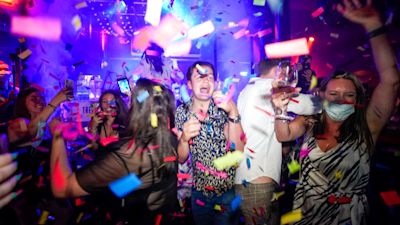 People dance shortly after the reopening, at The Piano Works in Farringdon, in London, Monday, July 19, 2021. Thousands of young people plan to dance the night away at 'Freedom Day' parties after midnight Sunday, when almost all coronavirus restrictions in England are to be scrapped. Nightclubs, which have been shuttered since March 2020, can finally reopen. (AP Photo/Alberto Pezzali)