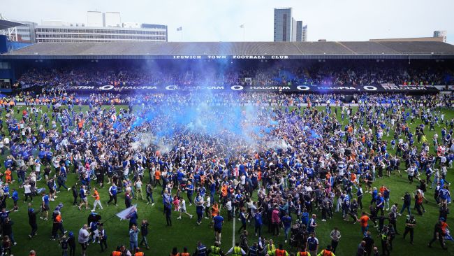 Ipswich fans invade the pitch at Portman Road after their club secured promotion to the Premier League.