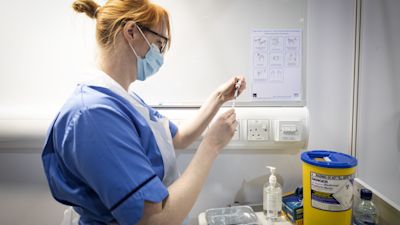 Nurse drawing up a booster jab
Picture: PA
