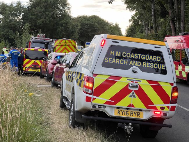Emergency services vehicles lined up near to the riverbank near Ovingham, in Northumberland.