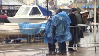 Couple in raincoats in Filey