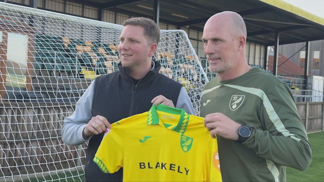 Philippe Clement (right) holds a Norwich City shirt alongside Sporting Director Ben Knapper (left).