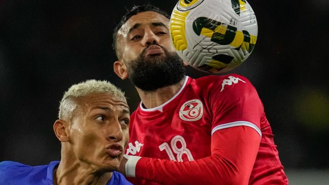Tunisia's Ghaylen Chaaleli, right, duels for the ball with Brazil's Richarlison during the international friendly soccer match