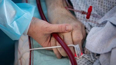 250322 Person holding hands in hospital PA
