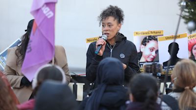 People attend the Million Women Rise vigil outside New Scotland Yard