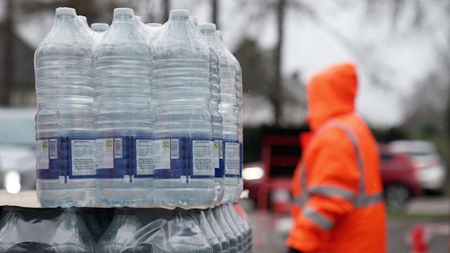 An image of South East Water staff handing out bottled water at a water station in Maidstone.
