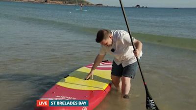 Gary with a paddle board in the sea
