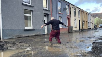 Rob (surname not given) walking through flood water as an apparent mud slide has forced people from their homes in Cwmtillery in Wales. Storm Bert will continue to bring disruption into Monday after torrential downpours caused "devastating" flooding over the weekend. Picture date: Monday November 25, 2024. PA Images.