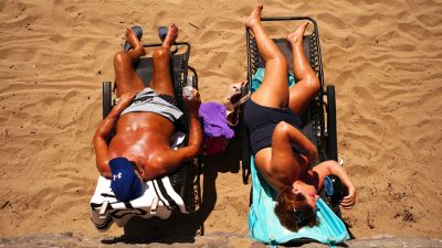 People on the beach at Barry Island, Wales enjoying the hot weather as Britons are set to sizzle on what could be the hottest day of the year so far, with temperatures predicted to possibly hit 33C. Picture date: Monday July 11, 2022.

