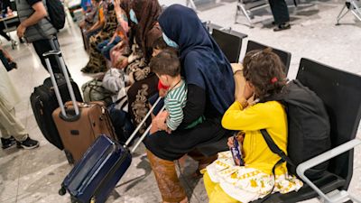Refugees from Afghanistan wait to be processed after arriving on a evacuation flight at Heathrow Airport, London. Picture date: Thursday August 26, 2021. Dominic Lipinski/PA