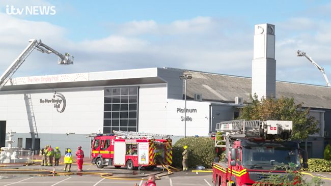 Fire crews are still putting the roof blaze out, 24 hours on