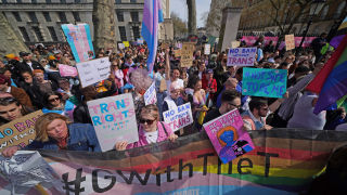 People take part in a demonstration outside Downing Street in London, to protest against the exclusion of transgender people from a ban on conversion therapy.