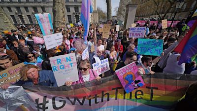 People take part in a demonstration outside Downing Street in London, to protest against the exclusion of transgender people from a ban on conversion therapy.