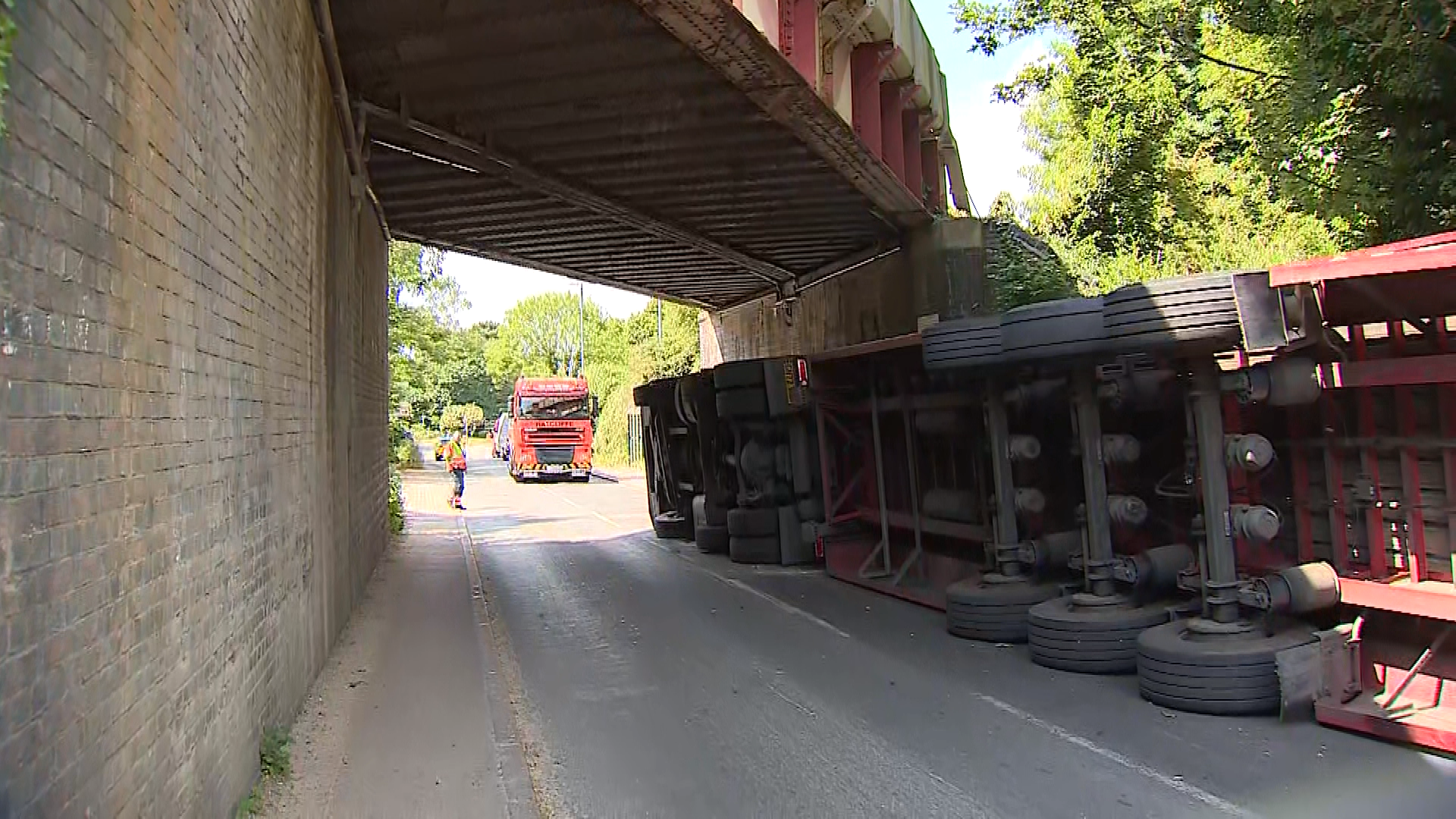 Lorry is flipped on to side after crashing under Cambridge railway