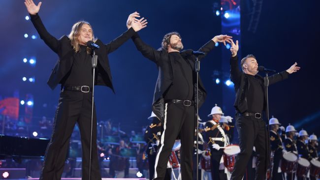 Gary Barlow, Howard Donald and Mark Owen of Take That perform on stage at the Coronation Concert