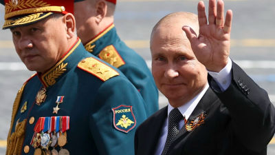 Russian President Vladimir Putin, right, and, Defense Minister Sergei Shoigu leave Red Square after the Victory Day military parade 2020.