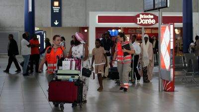 Red Cross workers take care of people evacuated from Niger at the Roissy Charles de Gaulle airport, north of Paris, France.