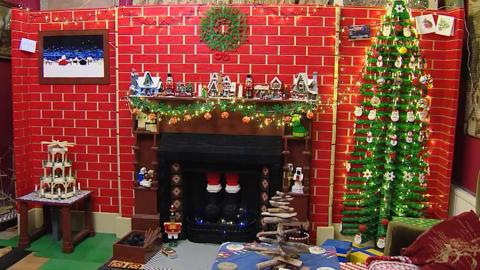 Lego-loving couple build a 12ft Lego Christmas wall complete with fireplace