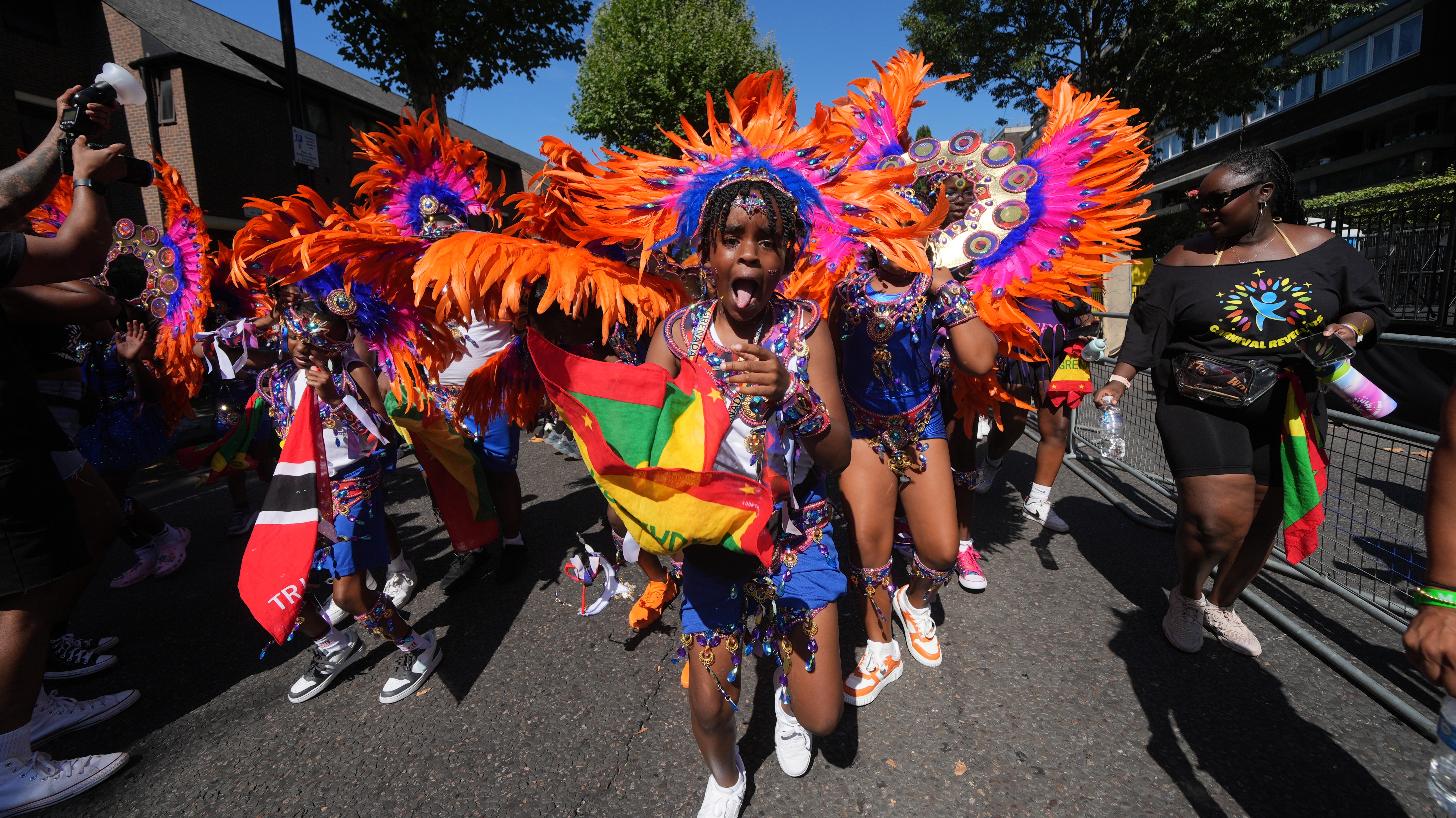 Notting Hill Carnival revellers party in the sunny streets