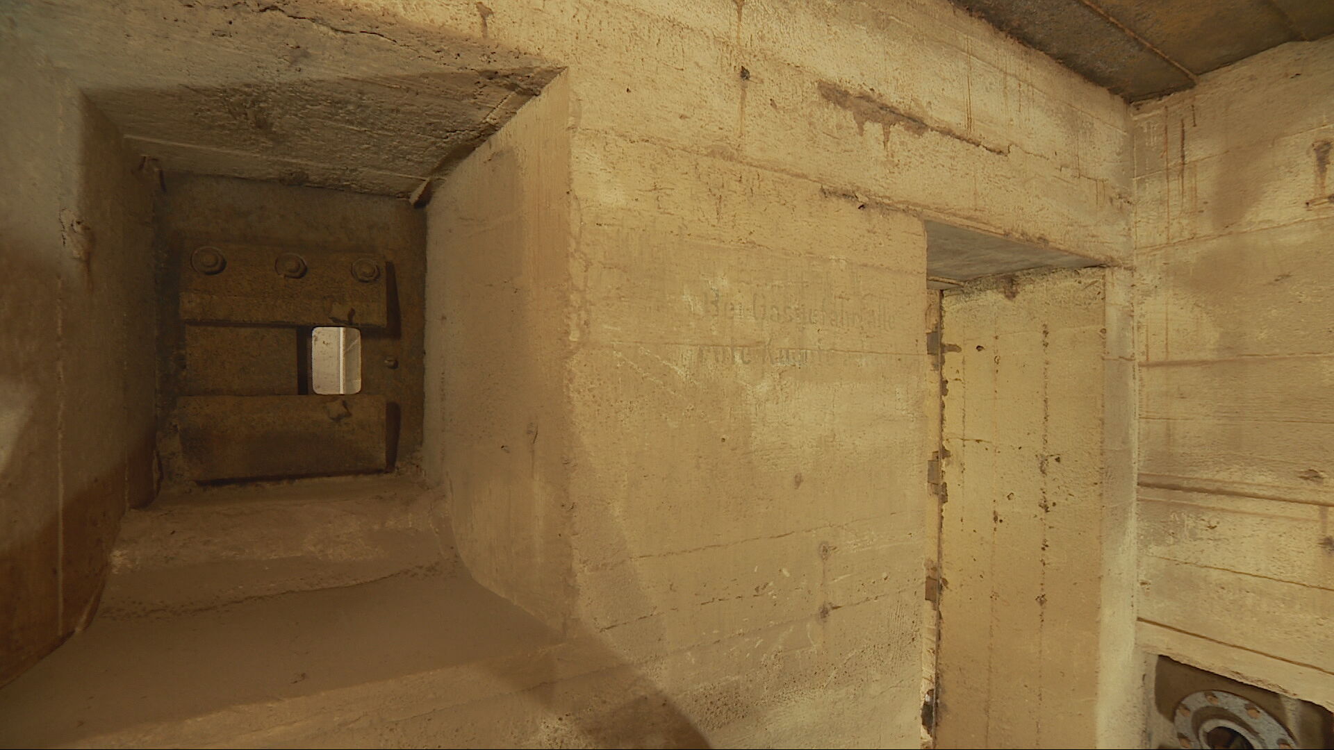 A section of the wall from an underground Second World War bunker, with a little hole described as a "rifle point".