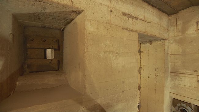 A section of the wall from an underground Second World War bunker, with a little hole described as a "rifle point".