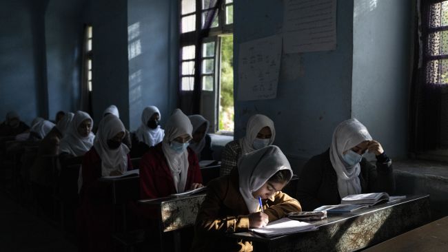 Afghan girls participate in a lesson at Tajrobawai Girls High School, Herat, last year before the bans took hold.