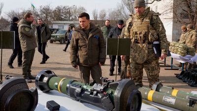 In this handout photo provided by the Ukrainian Presidential Press Office, President Volodymyr Zelenskyy inspects weapons during a visit to Ukrainian coast guards in Mariupol, Donetsk region, eastern Ukraine, Thursday, Feb. 17, 2022. In late January, Zelenskyy said that $12.5 billion had been withdrawn from accounts in the country. Last week, he called on members of parliament and businessmen who had fled to return. More than 20 charters and private jets left Kyiv last week, carrying some of the country's most prominent executives. (Ukrainian Presidential Press Office via AP, File)