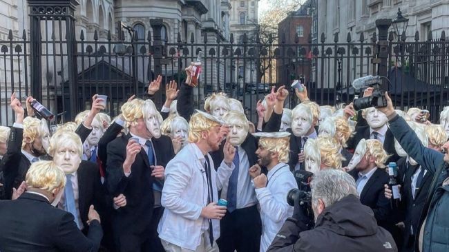 100 people dressed as the Prime Minister gather outside Downing Street to 'party'