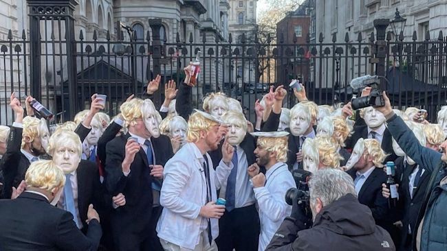 100 people dressed as the Prime Minister gather outside Downing Street to 'party'