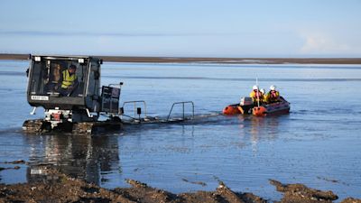 ANG 250224 Wells RNLI launched to help two people and three dogs cut off by the tide.