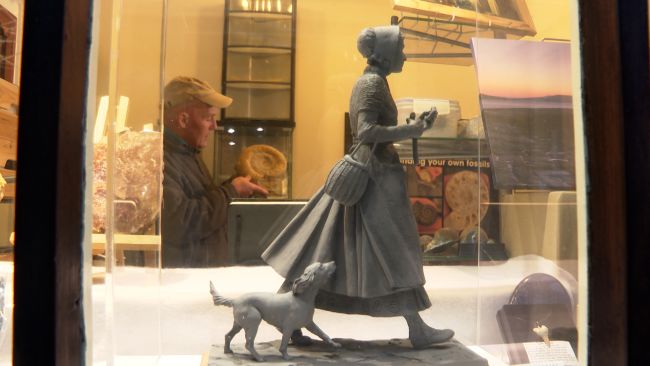 Model of Mary Anning with dog in shop window