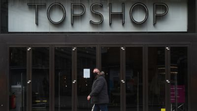 A man walks past the Topshop flagship store at Oxford Circus