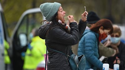 People take part in coronavirus surge testing on Clapham Common, south London. Thousands of residents have queued up to take coronavirus tests at additional facilities set up after new cases of the South African variant were found in two south London boroughs. 44 confirmed cases of the variant have been found in Lambeth and Wandsworth, with a further 30 probable cases identified. Picture date: Wednesday April 14, 2021. Kirsty O'Connor/PA