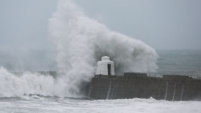Waves pound against the harbour wall at Portreath, Cornwall in 2020