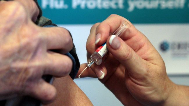 A flu vaccine being administered.