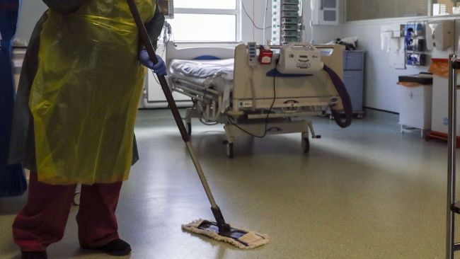  a cleaner working on a hospital ward