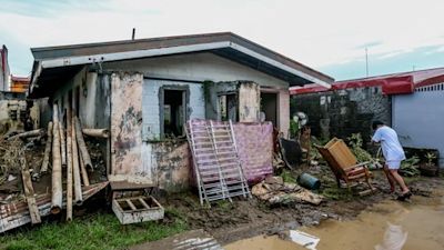 Residents salvage belongings after a flood triggered by heavy rains from Typhoon Goni in Batangas Province, the Philippines.
