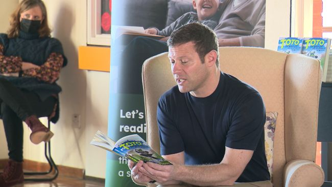 Dermot O'Leary reading to children at St Thomas More's Primary, Colchester.