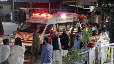 Rescue worker unload earthquake victims from an ambulance at a hospital in Saidu Sharif, a town Pakistan's Swat valley