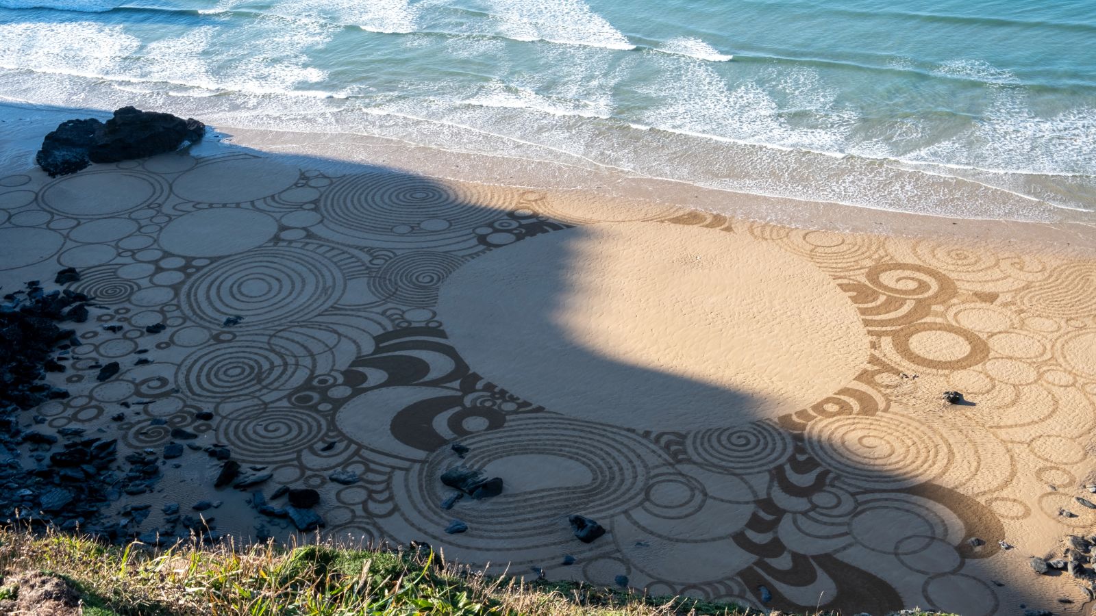 Falmouth students create stunning sand drawing on beach near Newquay ...