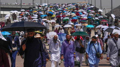 Muslim pilgrims use umbrellas to shield themselves from the sun during the Hajj.