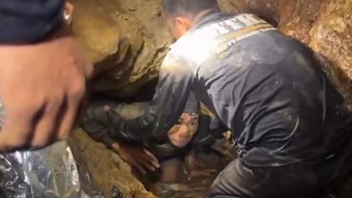 Four men rescued from flooded Laos cave as search continues for two missing