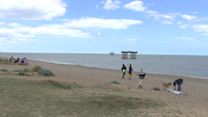 People walking on the beach near Sizewell power station in Suffolk.