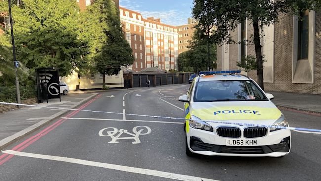 Police at the scene near Kensington High Street, London, where a man was shot in the early hours of Sunday morning, sparking a murder investigation. Officers found a man, believed to be in his 20s, with gunshot wounds and provided emergency first aid until the London Ambulance Service and London's Air Ambulance arrived. He was taken to a central London hospital where he died at 5:32am. Picture date: Sunday September 4, 2022.