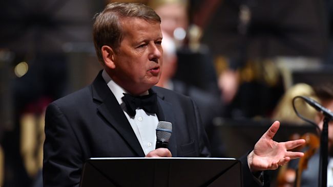 Bill Turnbull presents on stage with the Royal Liverpool Philharmonic Orchestra during Classic FM's 25th Birthday concert.