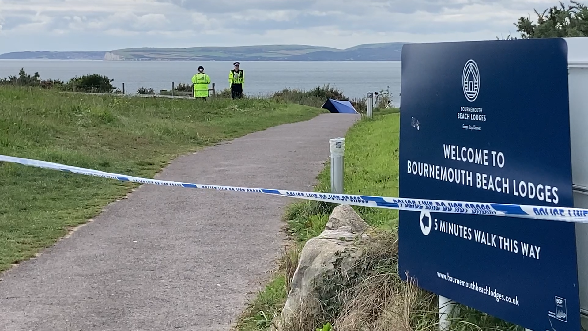 Officers Search Undergrowth After Human Remains Found Near Beach In ...