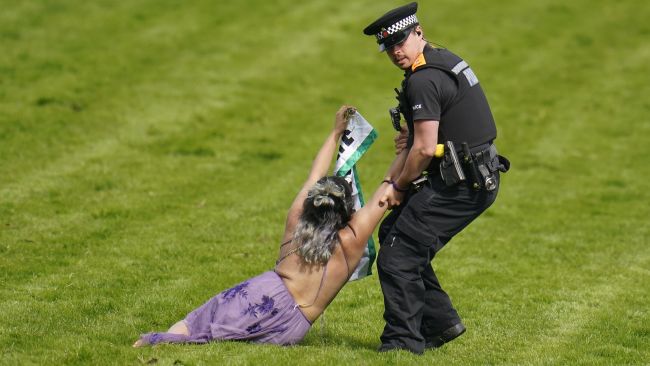 Protestors are removed from the racecourse ahead of the Derby on Derby Day during the Cazoo Derby Festival 2022 at Epsom Racecourse, Surrey. Picture date: Saturday June 4, 2022.
